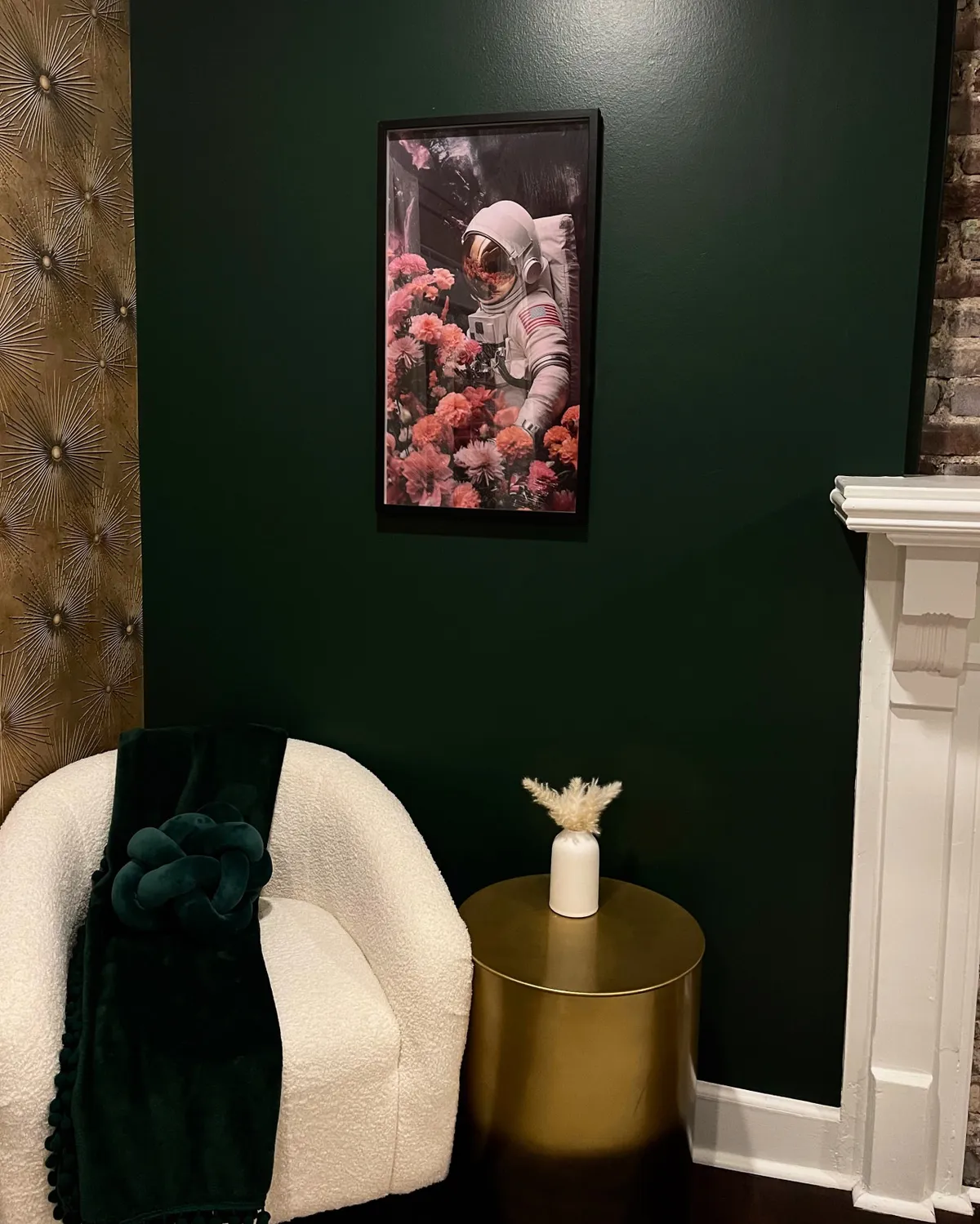 A stylish corner with plush seating, a green accent wall, framed astronaut artwork, and a golden side table. The décor is whimsical yet refined, creating a memorable and inviting spot for relaxation within the bedroom space.