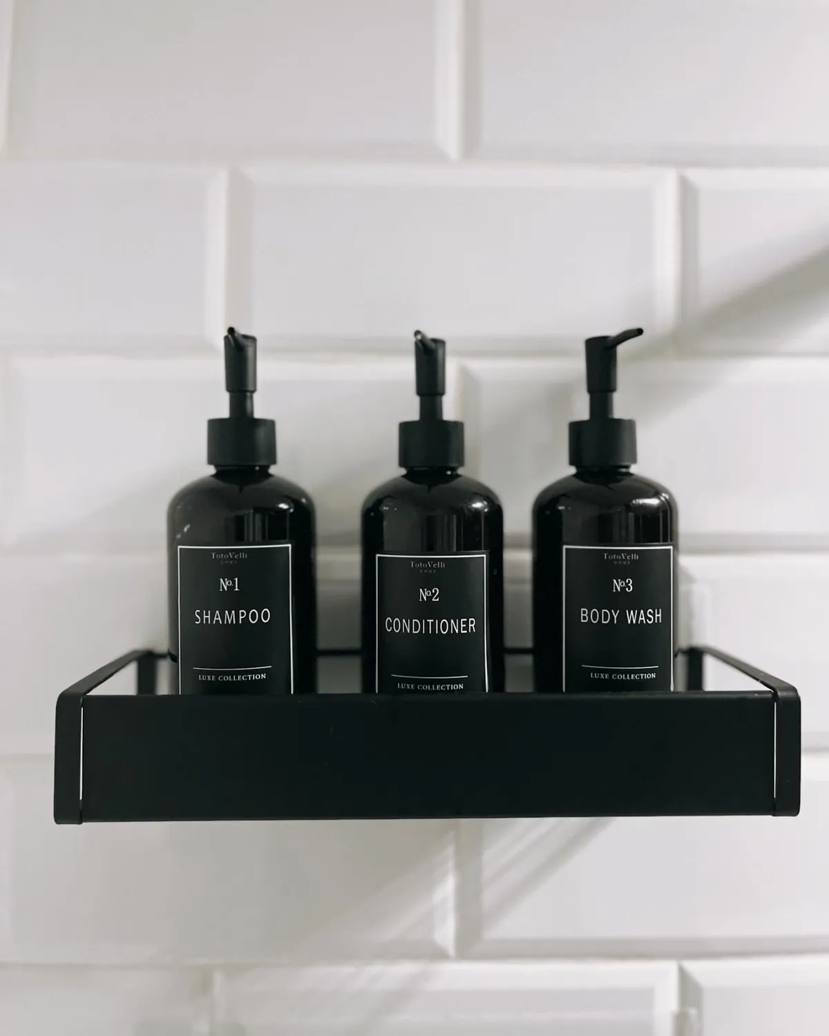 A spa-like bathroom setup with high-quality shampoo, conditioner, and body wash bottles displayed on the edge of a luxurious bathtub. The scene suggests moments of relaxation and self-care amid a busy schedule.